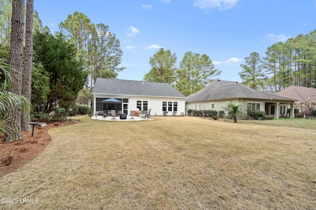 rear view of property featuring a patio area and a lawn