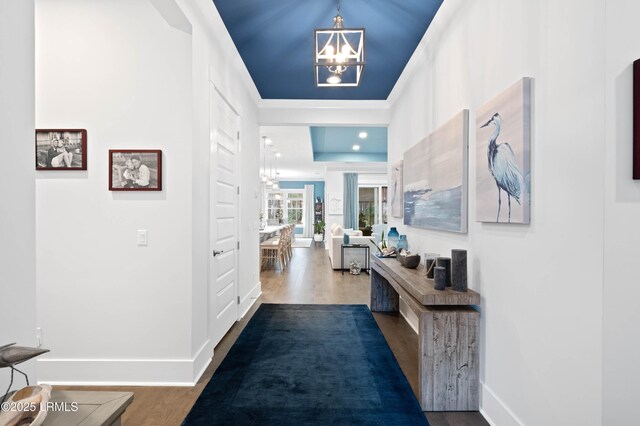 180 Alder Ln, Hardeeville, SC 29927 - hall with baseboards, wood finished floors, and a notable chandelier
