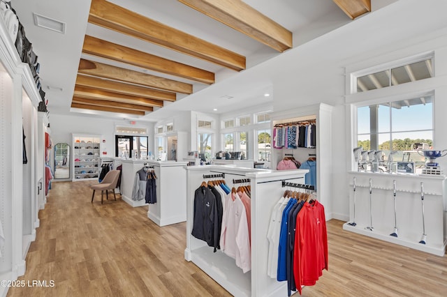 interior space with light hardwood / wood-style floors, washer and dryer, and a healthy amount of sunlight