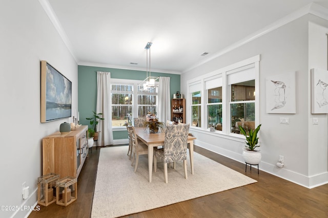 dining space with crown molding and dark wood-type flooring