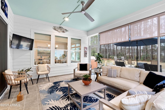 sunroom featuring ceiling fan