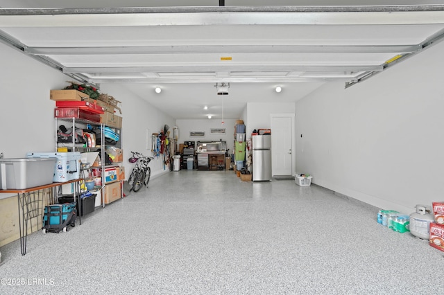 garage with water heater and stainless steel fridge