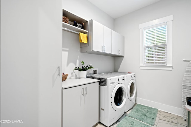 laundry area featuring cabinets and washing machine and clothes dryer