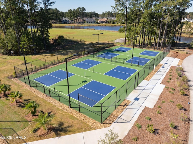 view of tennis court featuring a water view