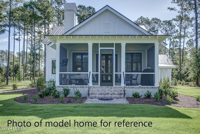 exterior space featuring a sunroom and a front yard