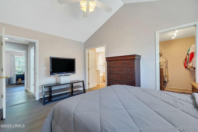 bedroom featuring ceiling fan, light hardwood / wood-style flooring, high vaulted ceiling, and ensuite bathroom