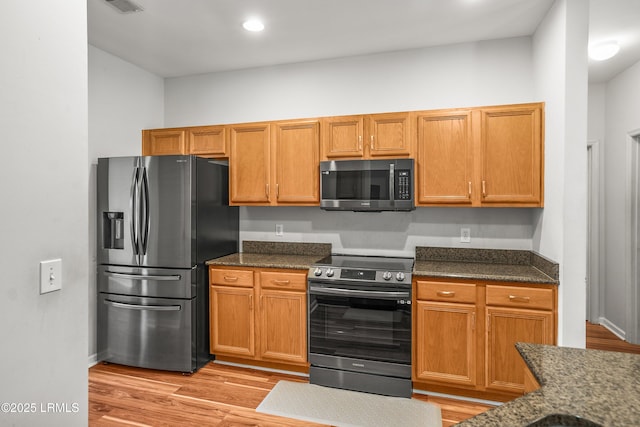 91 Heartstone Cir, Bluffton, SC 29910 - kitchen featuring appliances with stainless steel finishes, light wood-style flooring, and dark stone counters