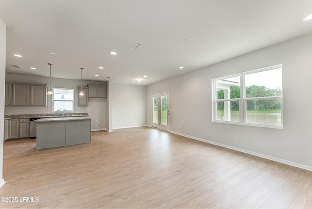 1109 Salty Hammock Ct, Beaufort, SC 29902 - unfurnished living room with recessed lighting, healthy amount of natural light, and light wood-style floors