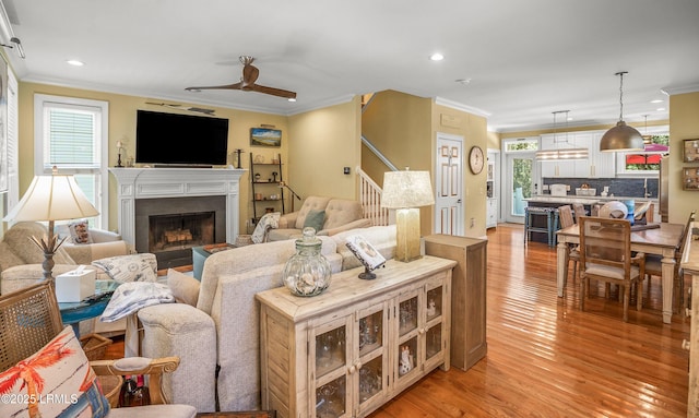 8 Battery Point Ln, Beaufort, SC 29902 - living area featuring light wood finished floors, recessed lighting, a fireplace, a ceiling fan, and crown molding