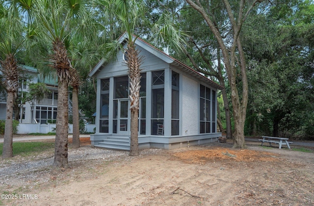 8 Battery Point Ln, Beaufort, SC 29902 - view of home's exterior featuring a sunroom and stucco siding