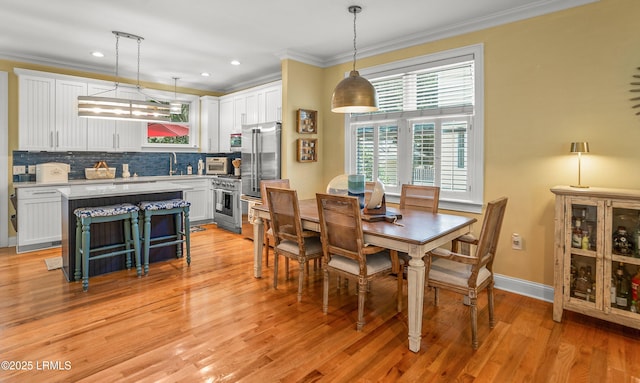 8 Battery Point Ln, Beaufort, SC 29902 - dining space with crown molding, light wood-type flooring, and recessed lighting