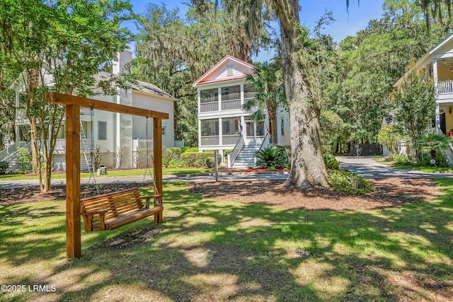 8 Battery Point Ln, Beaufort, SC 29902 - view of green lawn with a sunroom and stairway