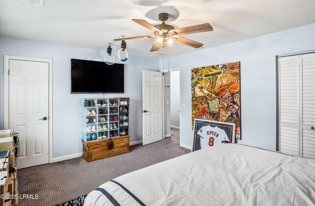 bedroom featuring dark carpet, a textured ceiling, and ceiling fan