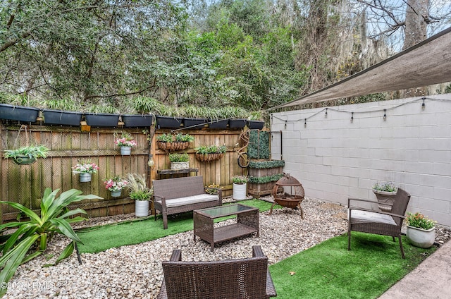 view of patio featuring an outdoor living space with a fire pit