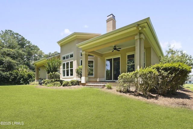 19 Lynnfield Pl, Bluffton, SC 29910 - rear view of property featuring ceiling fan, a lawn, a chimney, and stucco siding