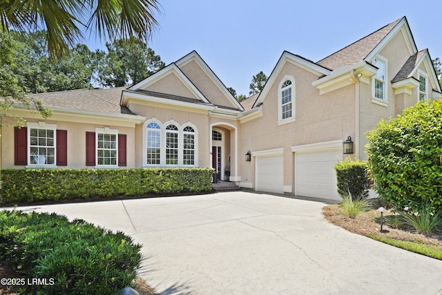 19 Lynnfield Pl, Bluffton, SC 29910 - view of front of home with a garage, stucco siding, concrete driveway, and a shingled roof