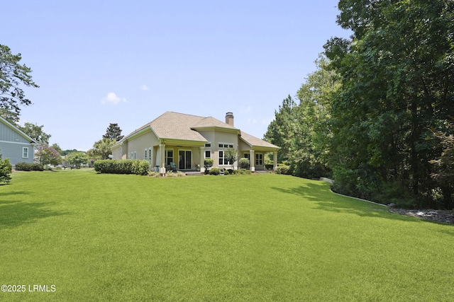 19 Lynnfield Pl, Bluffton, SC 29910 - rear view of house featuring a yard and a chimney