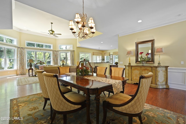 19 Lynnfield Pl, Bluffton, SC 29910 - dining room featuring crown molding, wood finished floors, a ceiling fan, a wainscoted wall, and a chandelier