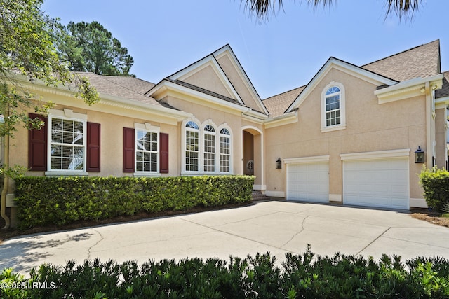 19 Lynnfield Pl, Bluffton, SC 29910 - view of front of home featuring driveway, stucco siding, roof with shingles, and an attached garage