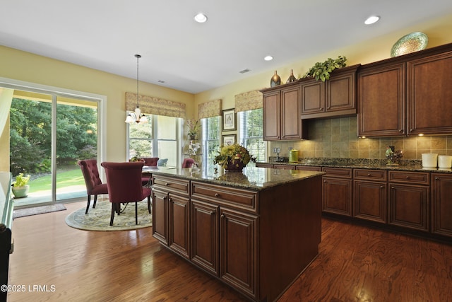 19 Lynnfield Pl, Bluffton, SC 29910 - kitchen featuring dark wood finished floors, dark stone countertops, hanging light fixtures, a kitchen island, and recessed lighting