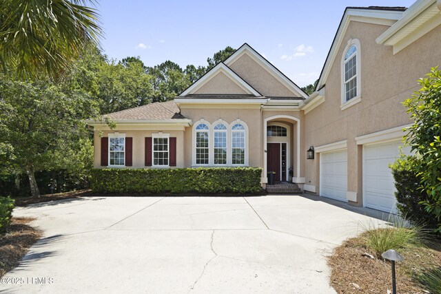 19 Lynnfield Pl, Bluffton, SC 29910 - view of front of house with stucco siding, concrete driveway, and an attached garage