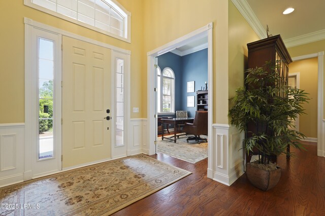 19 Lynnfield Pl, Bluffton, SC 29910 - foyer entrance featuring wainscoting, dark wood-type flooring, ornamental molding, and a decorative wall