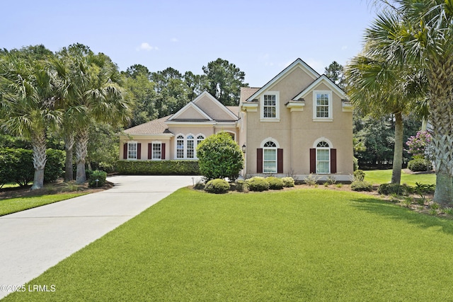 19 Lynnfield Pl, Bluffton, SC 29910 - view of front of home with stucco siding, a front lawn, and driveway