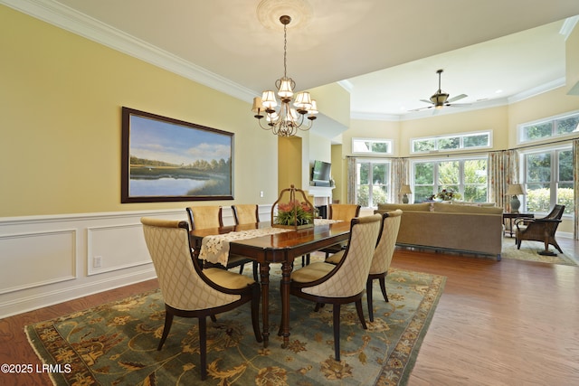 19 Lynnfield Pl, Bluffton, SC 29910 - dining space with a chandelier, crown molding, wood finished floors, a ceiling fan, and a wainscoted wall