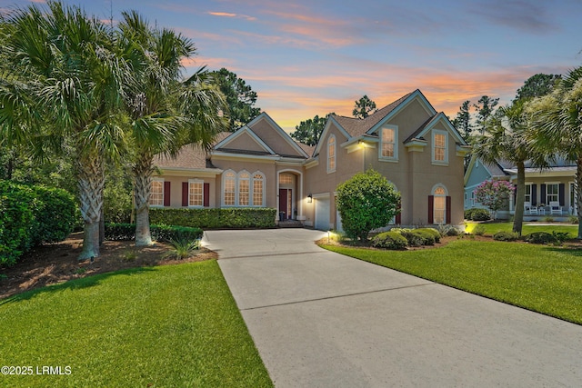 19 Lynnfield Pl, Bluffton, SC 29910 - traditional home featuring concrete driveway, stucco siding, and a front yard