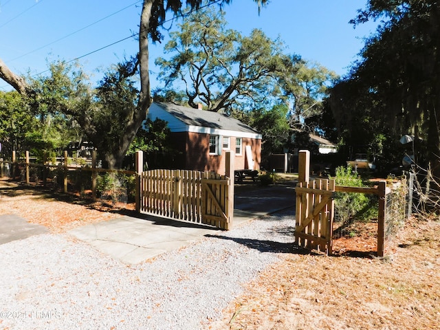 view of gate with an outdoor structure