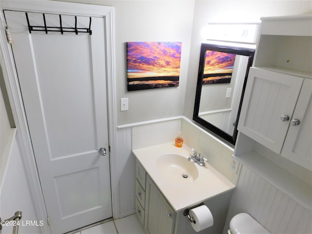 bathroom with vanity, tile patterned floors, and toilet