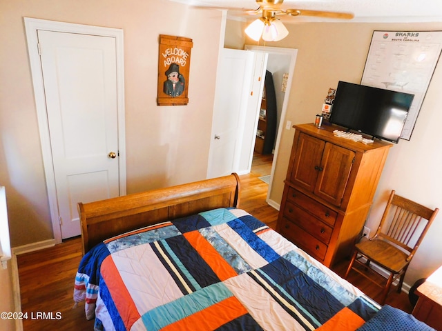 bedroom with dark wood-type flooring and ceiling fan