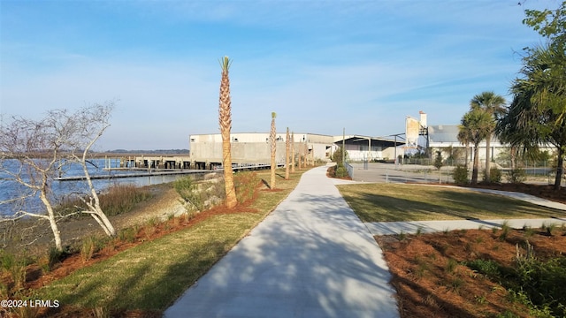 view of community with a water view and a dock