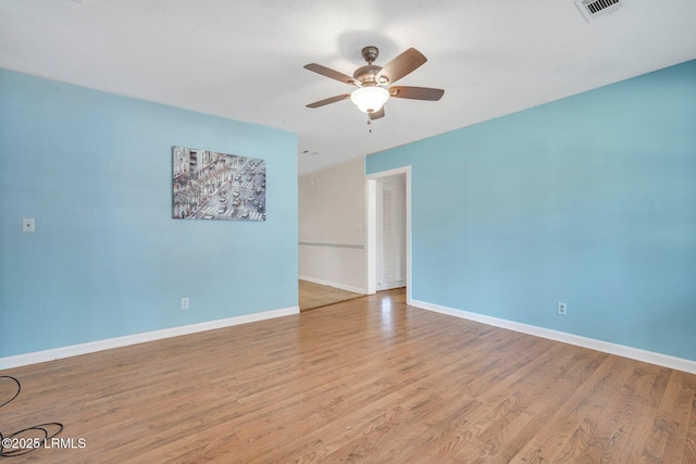 empty room with ceiling fan and light hardwood / wood-style floors