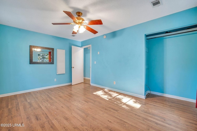 unfurnished bedroom with a textured ceiling, light hardwood / wood-style floors, a closet, and ceiling fan