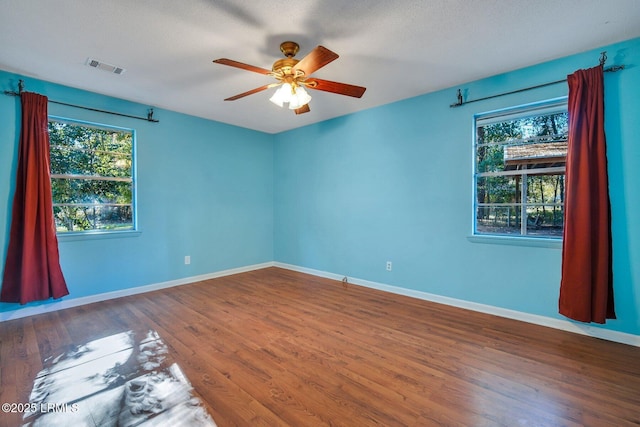 unfurnished room with hardwood / wood-style floors, a textured ceiling, and ceiling fan