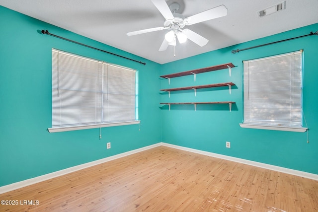 spare room featuring ceiling fan and light hardwood / wood-style floors