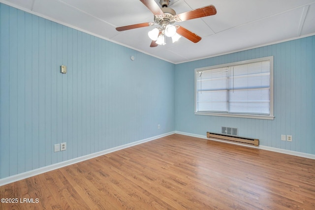 unfurnished room with hardwood / wood-style flooring, a baseboard radiator, ornamental molding, and ceiling fan