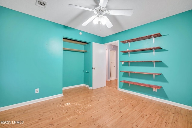 unfurnished bedroom with a closet, ceiling fan, and light wood-type flooring