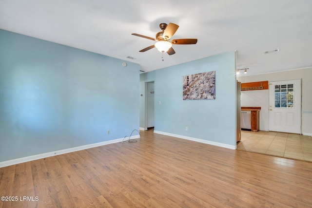 empty room with ceiling fan and light wood-type flooring