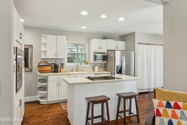 838 Fiddlers Ridge Rd, Fripp Island, SC 29920 - kitchen with open shelves, stainless steel appliances, white cabinetry, a kitchen island, and a kitchen bar
