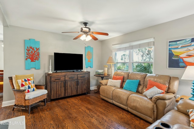 living room featuring a ceiling fan, baseboards, and dark wood-style flooring