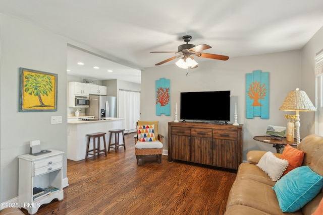 living area featuring ceiling fan, baseboards, dark wood-style floors, and recessed lighting