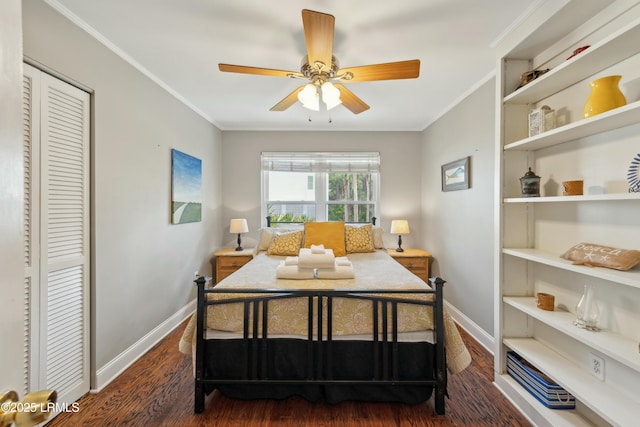 bedroom featuring baseboards, crown molding, and dark wood-style floors