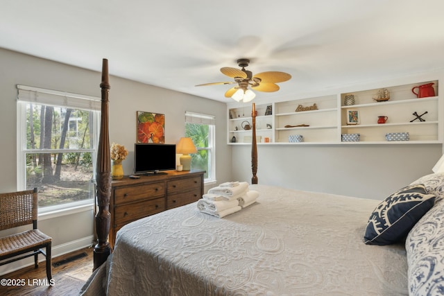 bedroom with wood finished floors, baseboards, and ceiling fan