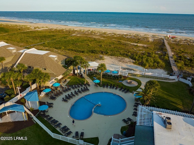 birds eye view of property featuring a water view and a beach view