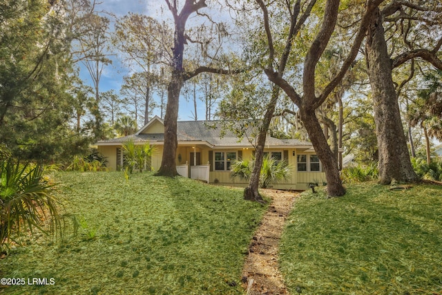 view of front of house featuring board and batten siding and a front lawn
