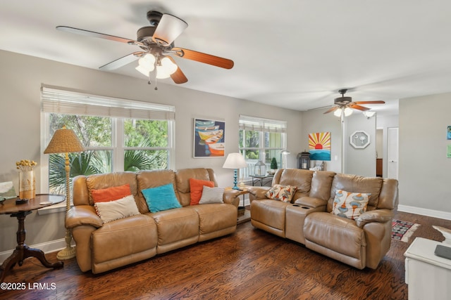 living area featuring ceiling fan, baseboards, and dark wood-style floors