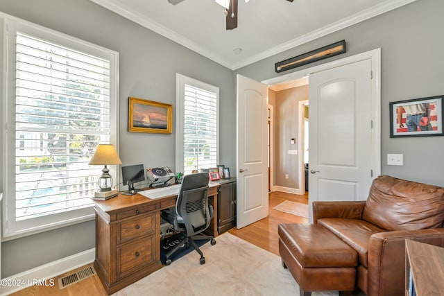 office area featuring crown molding, ceiling fan, plenty of natural light, and light hardwood / wood-style flooring