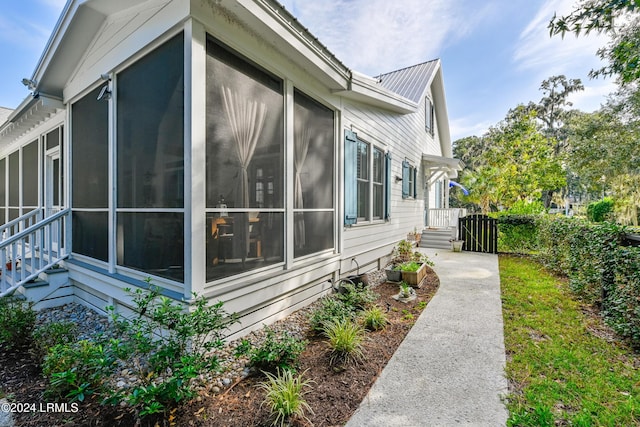 view of side of home featuring a sunroom